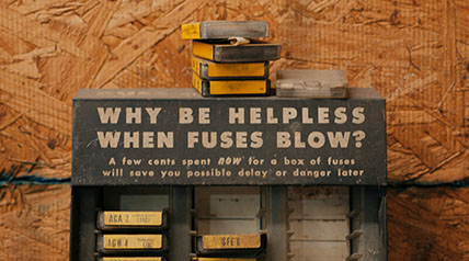 hardware store of fuses for sale with a sign that says "why be helpless when fuses blow?"