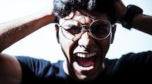 millennial man wearing glasses screaming, photo by Yogendra Singh from Unsplash
